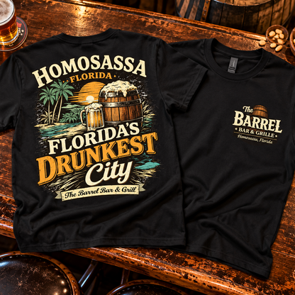 Black tee front and back on a bar table: Florida's Drunkest City back print and Barrel Bar & Grille left-chest logo